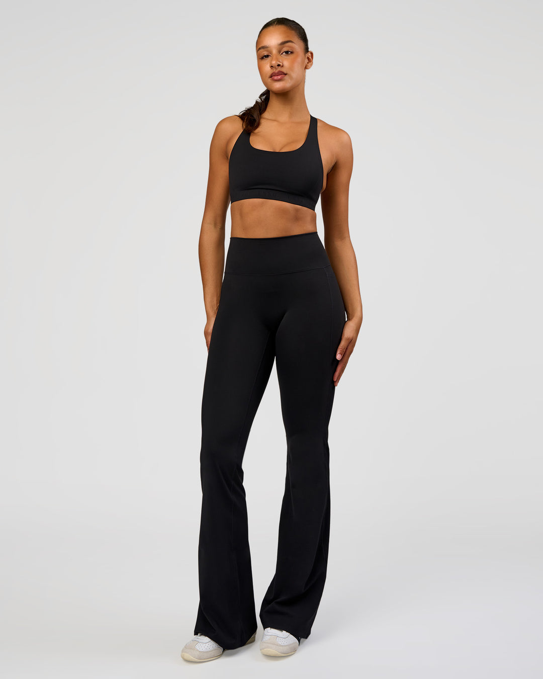 Woman wearing Fusion V-Contour High-Rise Flared Tall Legging Pockets - Black | Model:Rosie | Size:S - view 5