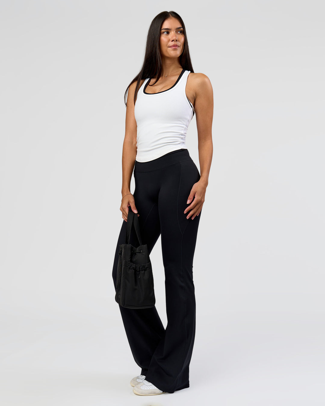 Woman wearing Fusion V-Contour High-Rise Flared Tall Legging Pockets - Black | Model:Rhiley | Size:S - view 7