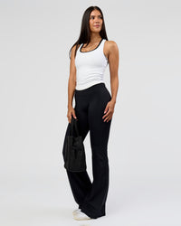 Woman wearing Fusion V-Contour High-Rise Flared Tall Legging Pockets - Black | Model:Rhiley | Size:S | Thumbnail Index: 6