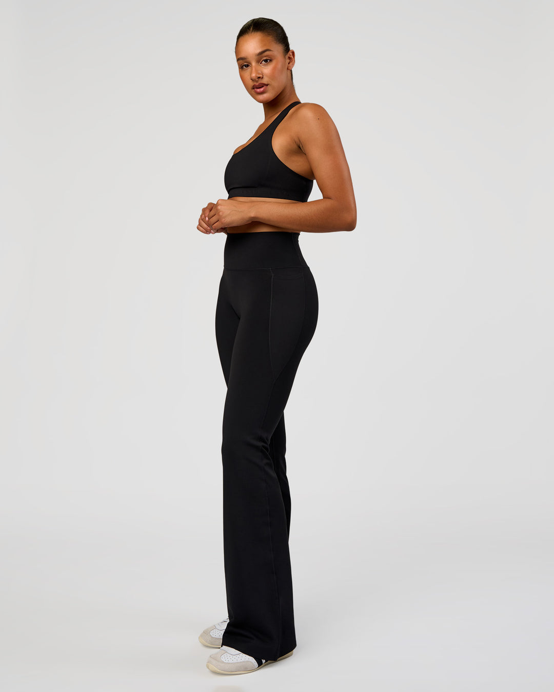 Woman wearing Fusion V-Contour High-Rise Flared Tall Legging Pockets - Black | Model:Rosie | Size:S - view 6