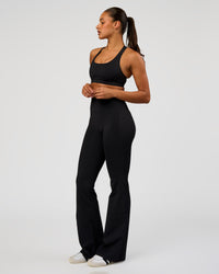 Woman wearing Fusion V-Contour High-Rise Flared Tall Legging Pockets - Black | Model:Rosie | Size:S | Thumbnail Index: 7