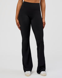Woman wearing Fusion V-Contour High-Rise Flared Tall Legging Pockets - Black | Model:Rosie | Size:S | Thumbnail Index: 8