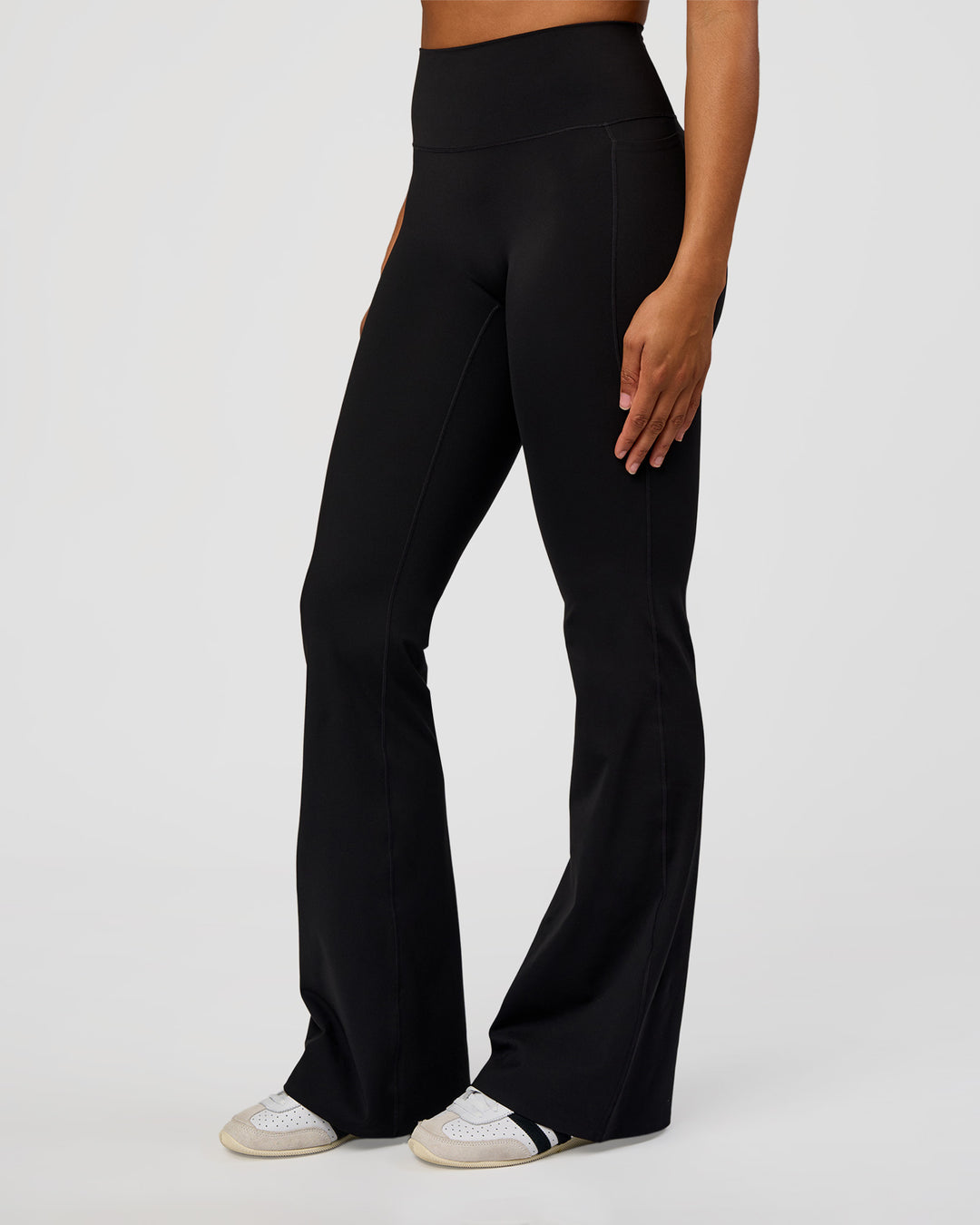 Woman wearing Fusion V-Contour High-Rise Flared Tall Legging Pockets - Black | Model:Rosie | Size:S - view 1
