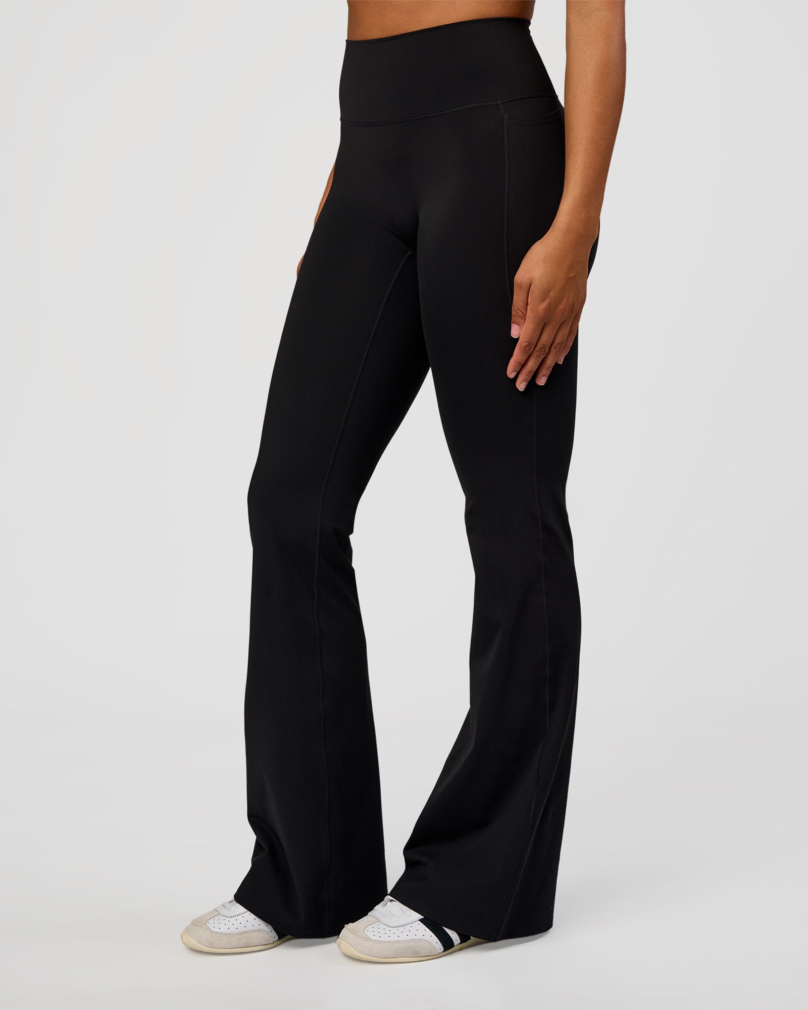 Woman wearing Fusion V-Contour High-Rise Flared Tall Legging Pockets - Black | Model:Rosie | Size:S