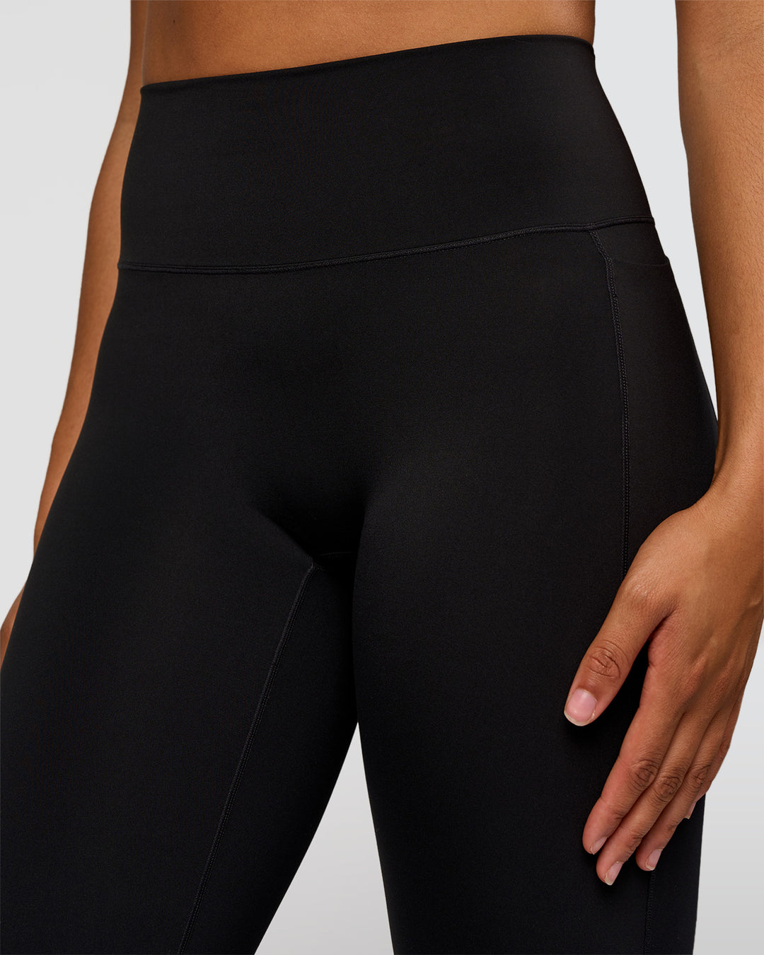 Woman wearing Fusion V-Contour High-Rise Flared Tall Legging Pockets - Black | Model:Rosie | Size:S - view 3
