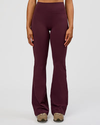 Woman wearing Fusion V-Contour High-Rise Flared Tall Legging Pockets - Cherry Lacquer | Model:Rosie | Size:S | Thumbnail Index: 0