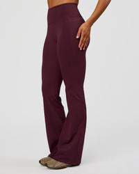 Woman wearing Fusion V-Contour High-Rise Flared Tall Legging Pockets - Cherry Lacquer | Model:Rosie | Size:S | Thumbnail Index: 3