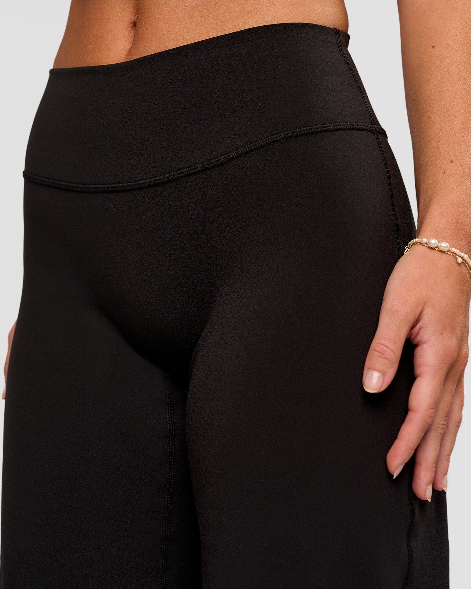 Woman wearing Fusion V-Contour High-Rise Petite Pant - Black | Model:Issy | Size:XS