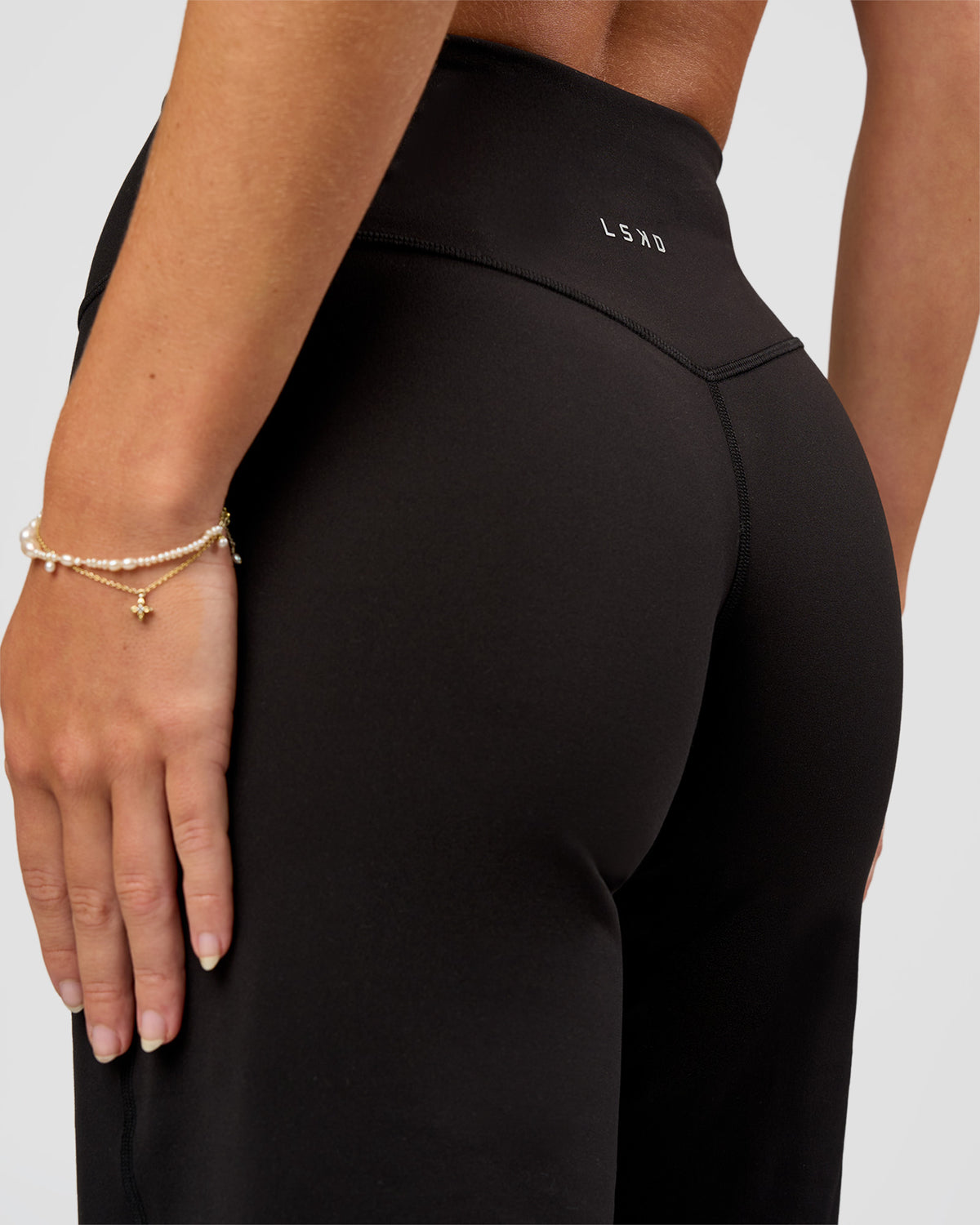 Woman wearing Fusion V-Contour High-Rise Petite Pant - Black | Model:Issy | Size:XS