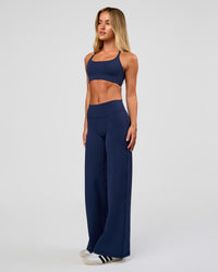 Model wearing Fusion V-Contour High-Rise Petite Pant - Future Navy | Model:Issy | Size:XS | Thumbnail Index: 5