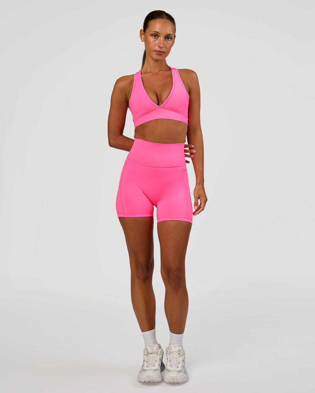 Woman wearing Fusion V-Contour Ultra High-Rise 4” Short Pockets - Sugar Plum | Model:Brylee | Size:XS - view 8