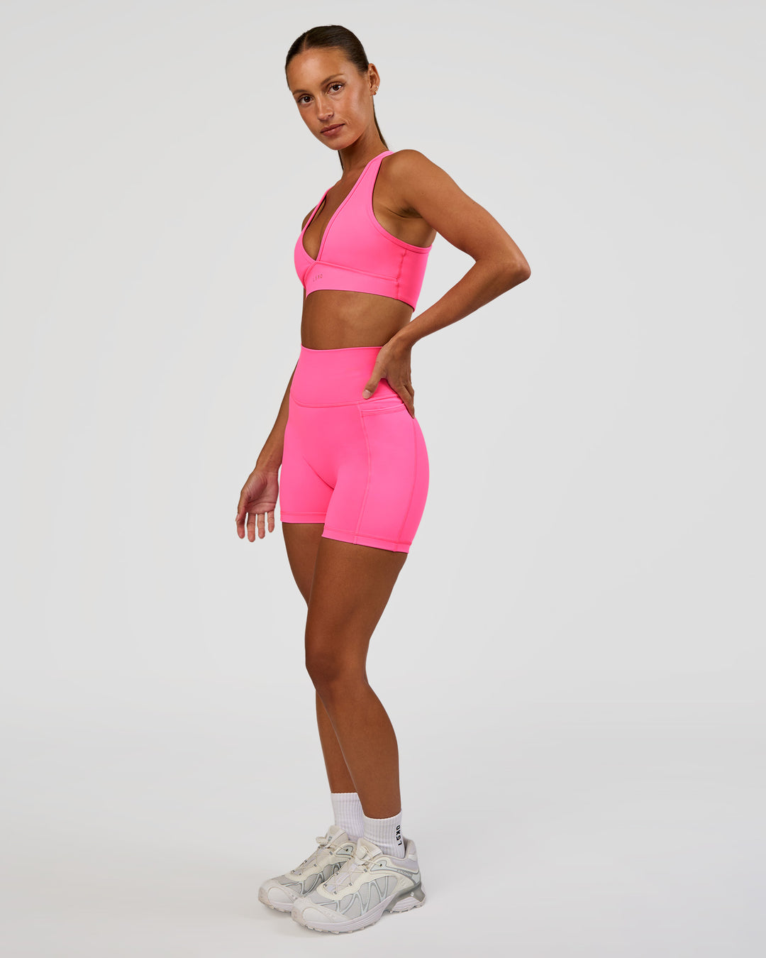 Woman wearing Fusion V-Contour Ultra High-Rise 4” Short Pockets - Sugar Plum | Model:Brylee | Size:XS - view 4