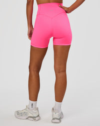 Woman wearing Fusion V-Contour Ultra High-Rise 4” Short Pockets - Sugar Plum | Model:Brylee | Size:XS | Thumbnail Index: 8