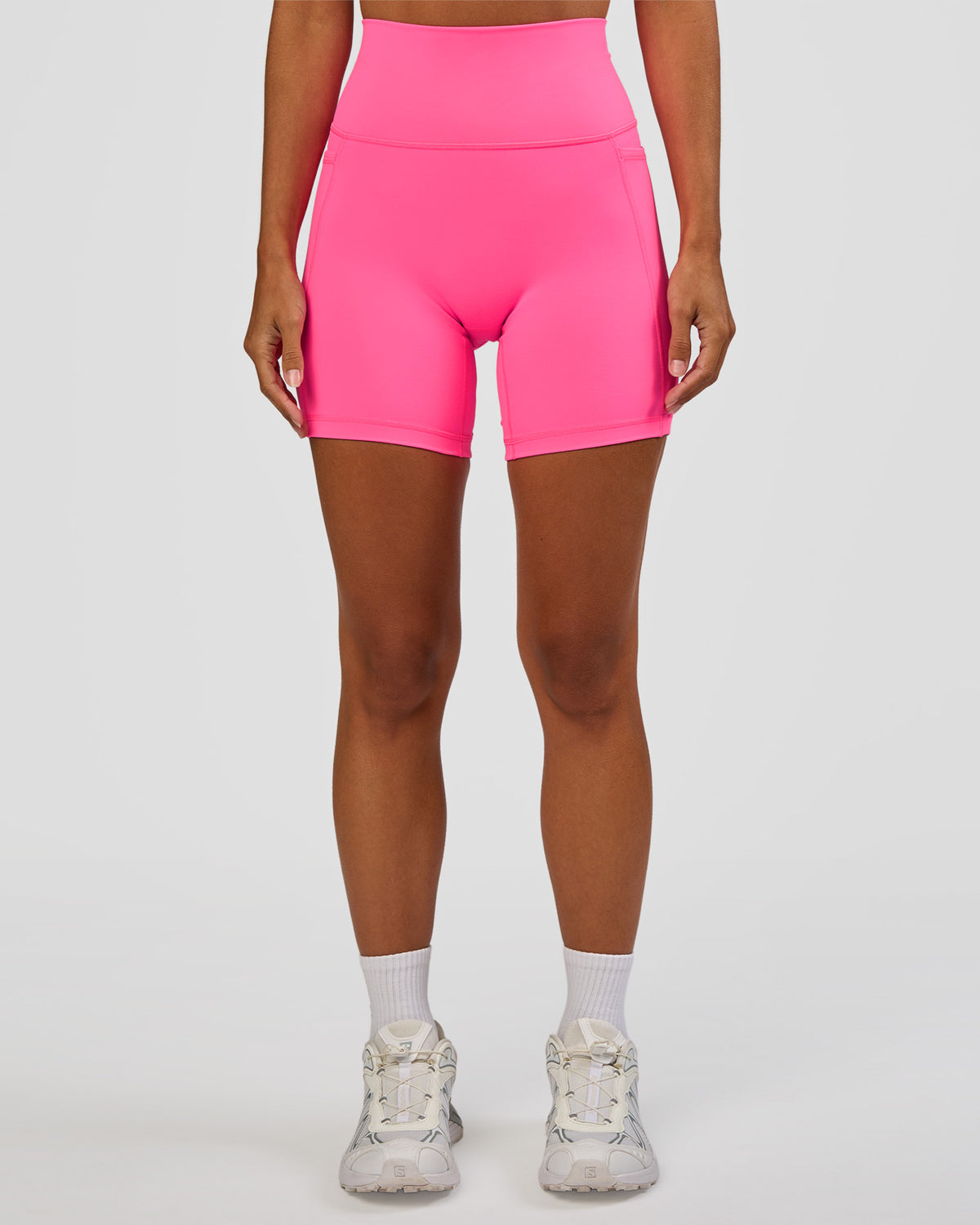 Woman wearing Fusion V-Contour Ultra High-Rise 6" Short Pockets - Sugar Plum | Model:Brylee | Size:XS