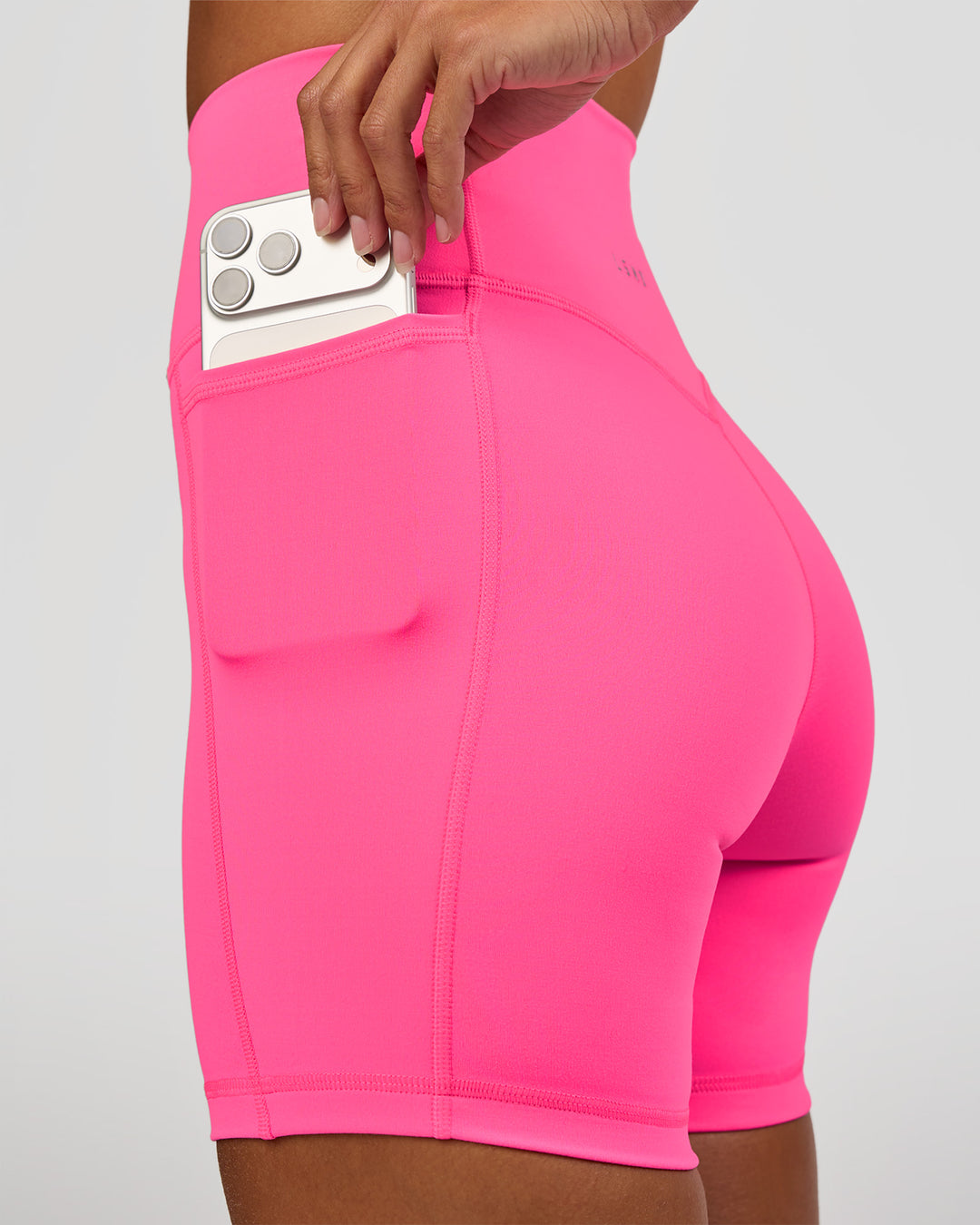 Woman wearing Fusion V-Contour Ultra High-Rise 6" Short Pockets - Sugar Plum | Model:Brylee | Size:XS - view 2
