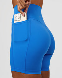 Woman wearing Fusion V-Contour Ultra High-Rise 6" Short Pockets - Palace Blue | Model:Brylee | Size:XS | Thumbnail Index: 0
