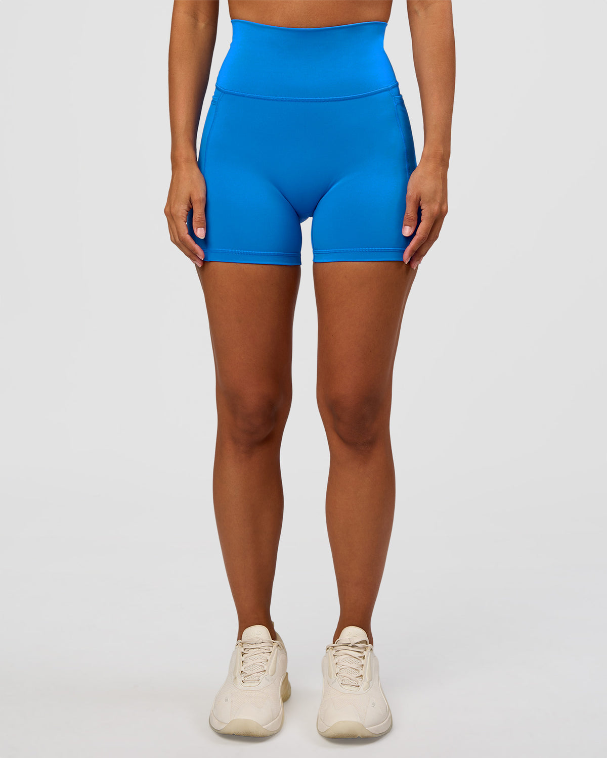Woman wearing Fusion V-Contour Ultra High-Rise 4" Short Pockets - Palace Blue | Model:Brylee | Size:XS
