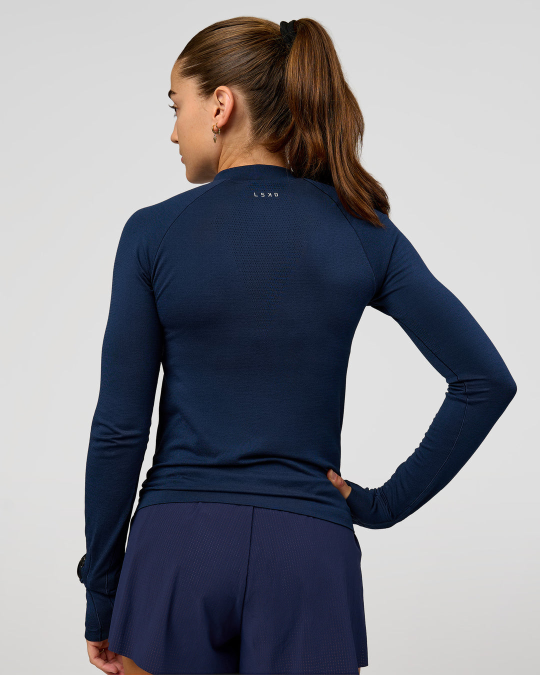 Woman wearing GG AeroFLX+ Long Sleeve Half Zip - Future Navy-Baltic Sea | Model:Grace | Size:XS - view 4