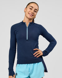 Woman wearing GG AeroFLX+ Long Sleeve Half Zip - Future Navy-Baltic Sea | Model:Grace | Size:XS | Thumbnail Index: 6