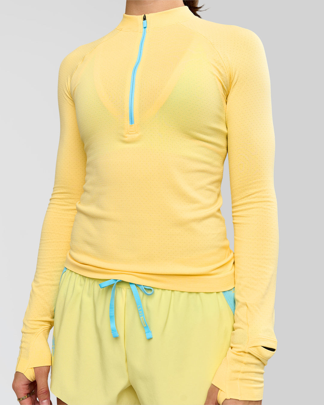 Woman wearing GG AeroFLX+ Long Sleeve Half Zip - Lemon-Baltic Sea | Model:Grace | Size:XS - view 10