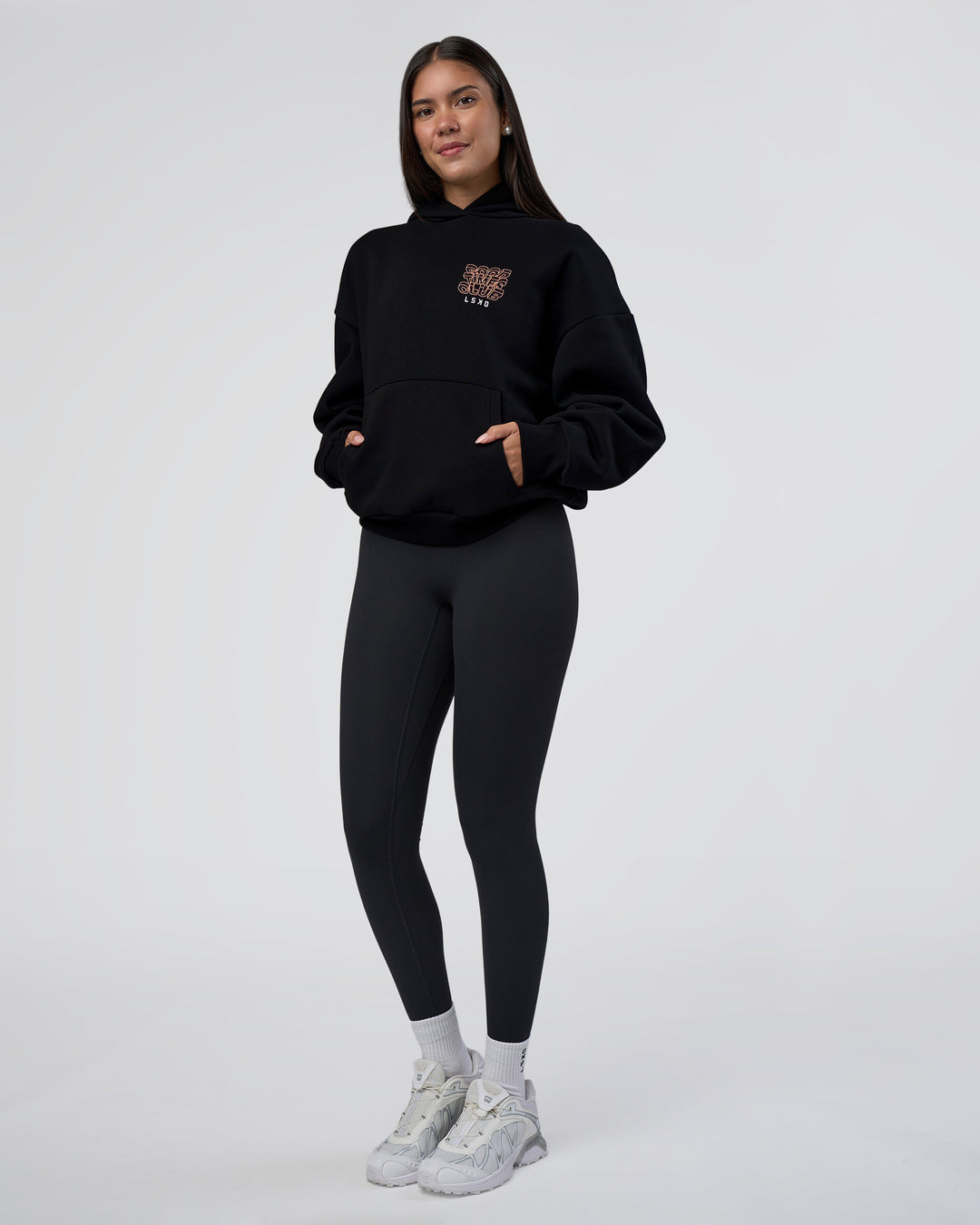 Woman wearing GTC CVC Fleece Unisex Oversized Hoodie - Black-Cantaloupe | Model:Rhiley | Size:XS - view 9