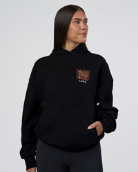 Woman wearing GTC CVC Fleece Unisex Oversized Hoodie - Black-Cantaloupe | Model:Rhiley | Size:XS | Thumbnail Index: 2