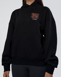 Woman wearing GTC CVC Fleece Unisex Oversized Hoodie - Black-Cantaloupe | Model:Rhiley | Size:XS | Thumbnail Index: 9