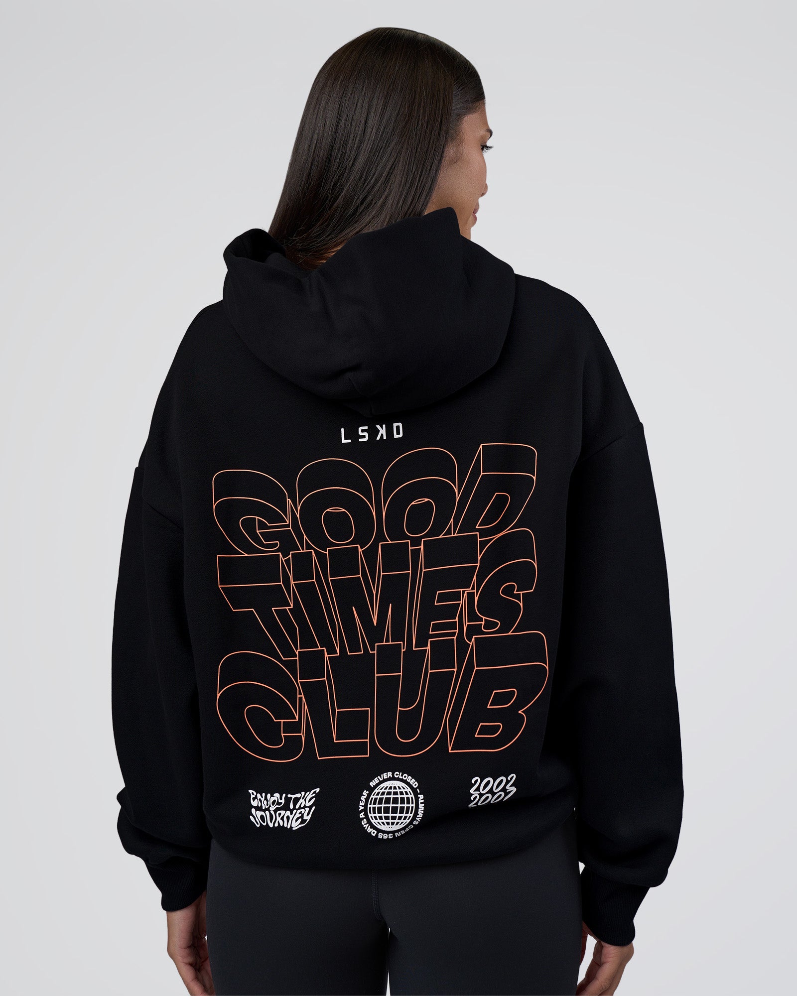Woman wearing GTC CVC Fleece Unisex Oversized Hoodie - Black-Cantaloupe | Model:Rhiley | Size:XS