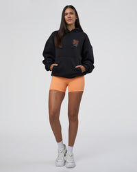 Woman wearing GTC CVC Fleece Unisex Oversized Hoodie - Black-Cantaloupe | Model:Rhiley | Size:XS | Thumbnail Index: 5