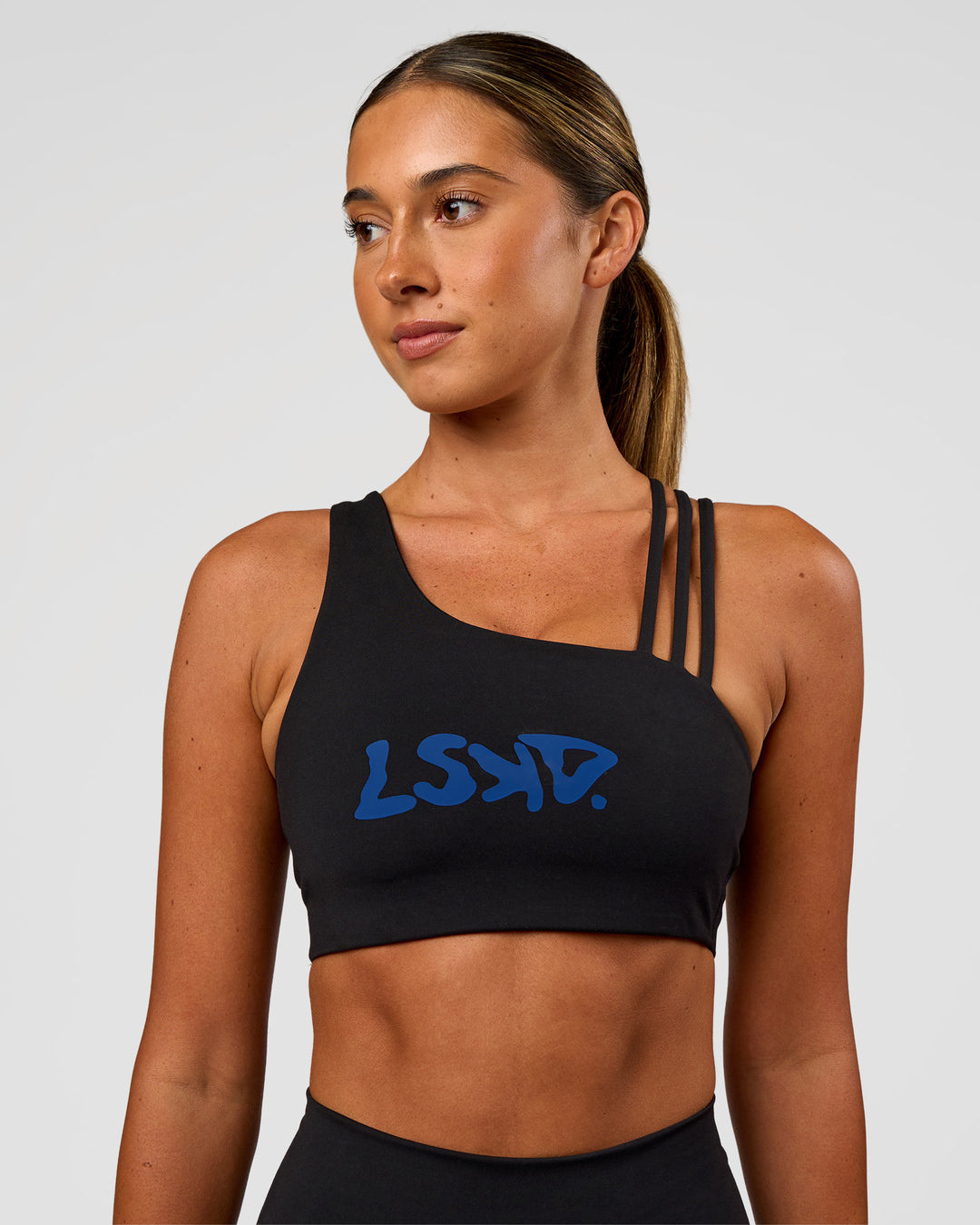 Woman wearing Galvanise Hype Graphic Sports Bra 2.0 - Black-Electric Indigo | Model:Charli | Size:XS - view 7