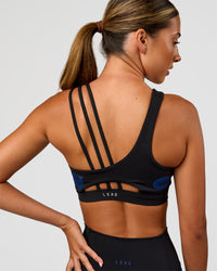 Woman wearing Galvanise Hype Graphic Sports Bra 2.0 - Black-Electric Indigo | Model:Charli | Size:XS | Thumbnail Index: 1