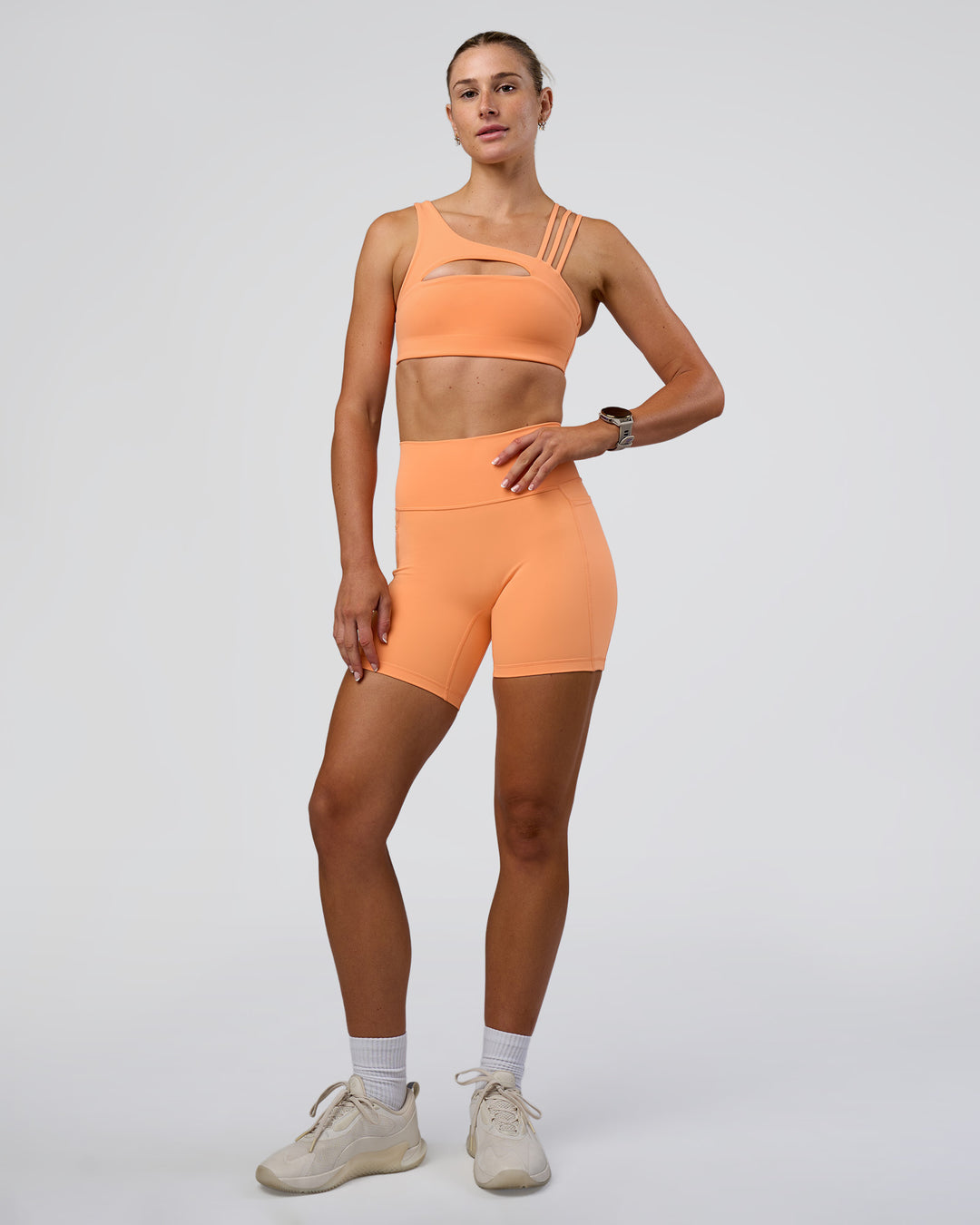 Woman wearing Galvanise Splice Sports Bra - Cantaloupe | Model:Emelia | Size:XS - view 5