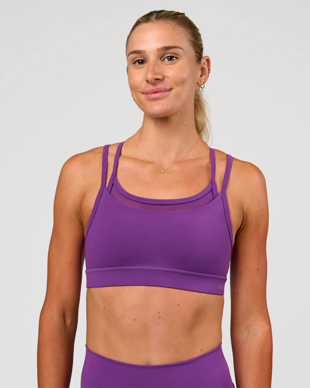 Woman wearing Genesis Layered Sports Bra - Fresh Purple | Model:Emelia | Size:XS - view 1