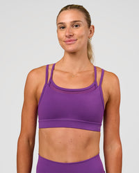 Woman wearing Genesis Layered Sports Bra - Fresh Purple | Model:Emelia | Size:XS | Thumbnail Index: 0