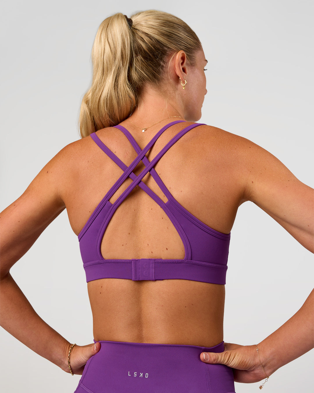 Woman wearing Genesis Layered Sports Bra - Fresh Purple | Model:Emelia | Size:XS - view 2