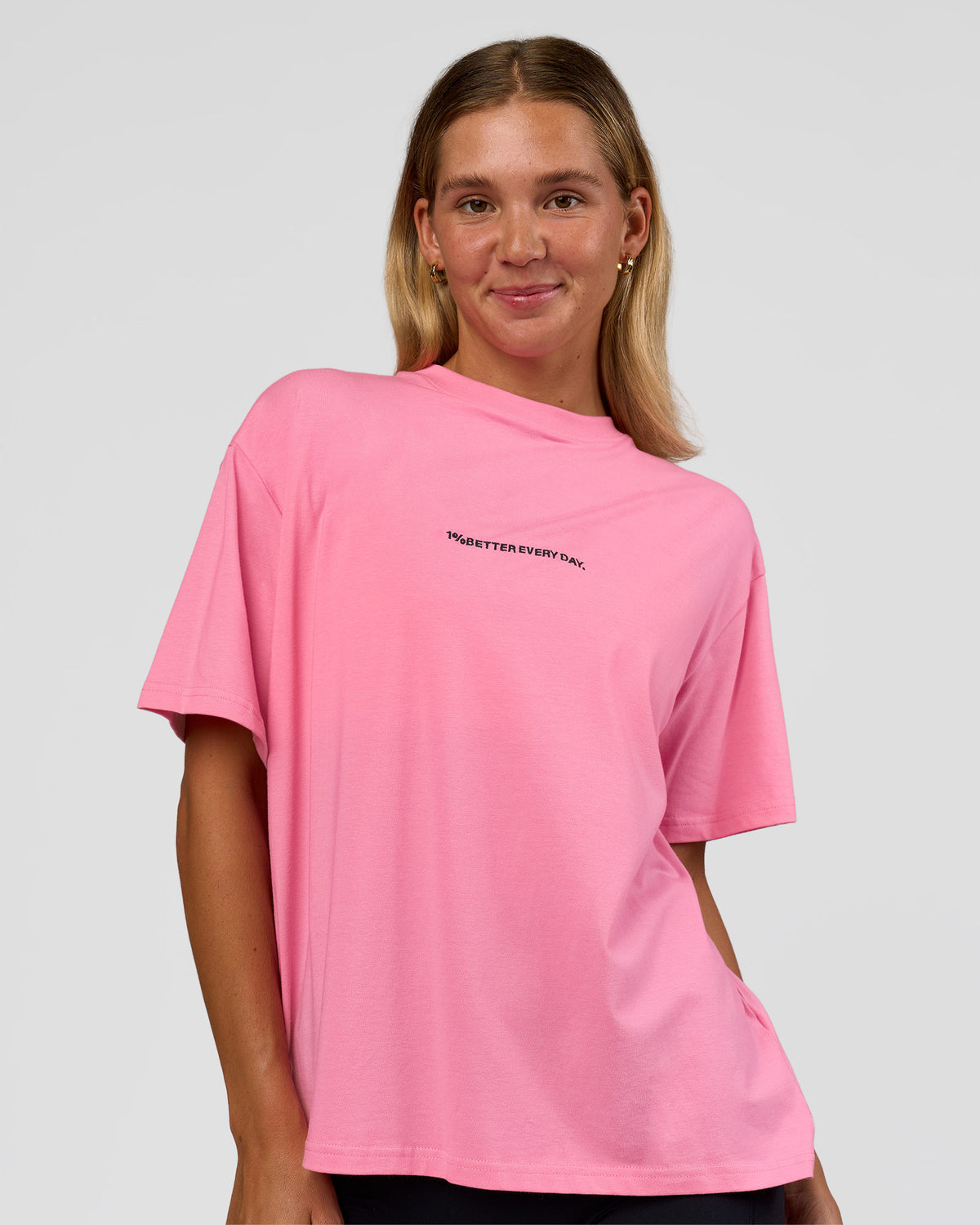 Woman wearing Go-To 1% Better Every Day FLXCotton Oversized Tee - Candy Pink-Black | Model:Amity | Size:XS