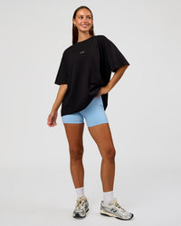 Woman wearing Go-To Break Through FLXCotton Oversized Tee - Black-Open Air | Model:Brylee | Size:XS | Thumbnail Index: 1