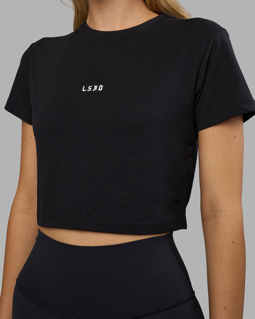 Woman wearing Go-To FLXCotton Baby Tee - Black-White | Model:Leilani | Size:XS - view 5