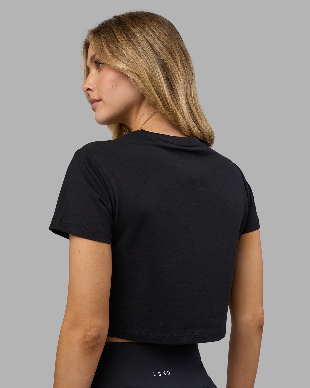 Woman wearing Go-To FLXCotton Baby Tee - Black-White | Model:Leilani | Size:XS - view 3