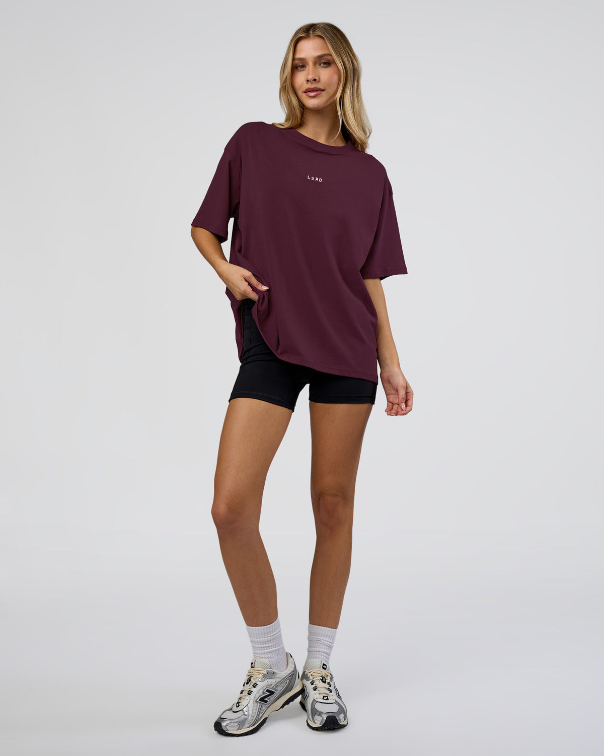 Woman wearing Go-To FLXCotton Oversized Tee - Cherry Lacquer-White | Model:Leilani | Size:XS