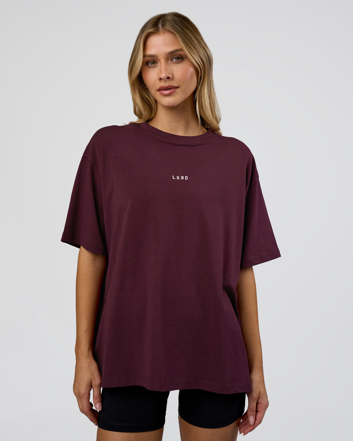 Woman wearing Go-To FLXCotton Oversized Tee - Cherry Lacquer-White | Model:Leilani | Size:XS