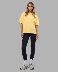Woman wearing Go-To FLXCotton Oversized Tee - Lemon-White | Model:Leilani | Size:XS | Thumbnail Index: 1