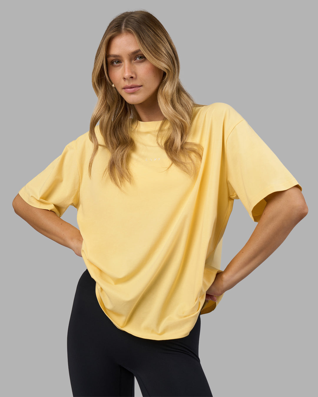 Woman wearing Go-To FLXCotton Oversized Tee - Lemon-White | Model:Leilani | Size:XS - view 1