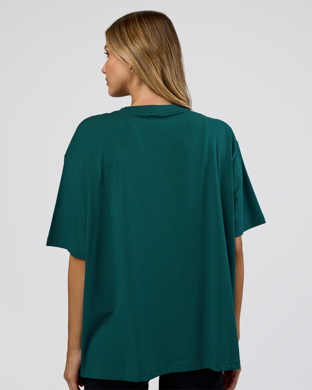 Woman wearing Go-To FLXCotton Oversized Tee - Transformative Teal-White | Model:Leilani | Size:XS - view 3