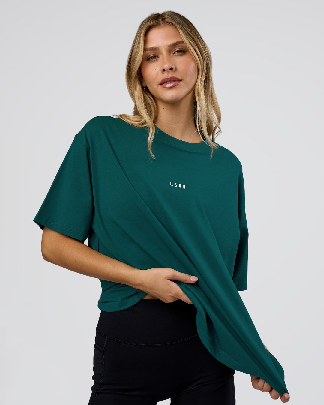 Woman wearing Go-To FLXCotton Oversized Tee - Transformative Teal-White | Model:Leilani | Size:XS - view 1