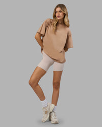 Woman wearing Go-To FLXCotton Oversized Tee - Warm Smoke-White | Model:Leilani | Size:XS | Thumbnail Index: 0