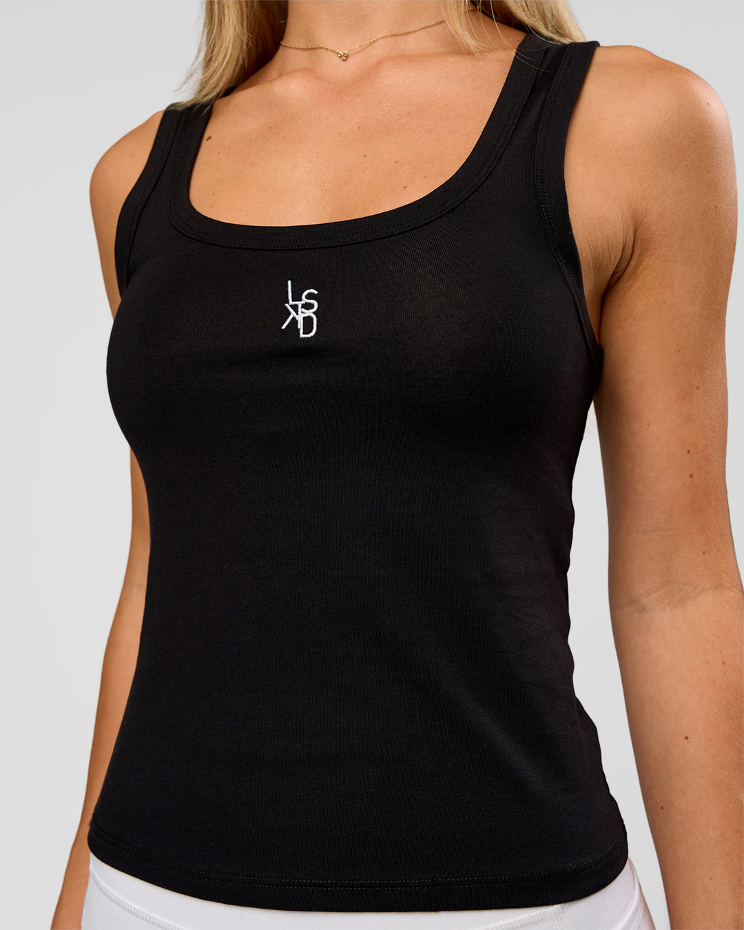 Woman wearing Go-To FLXCotton Scoop Neck Tank in Black-White | Model:Issy | Size:XS - view 1