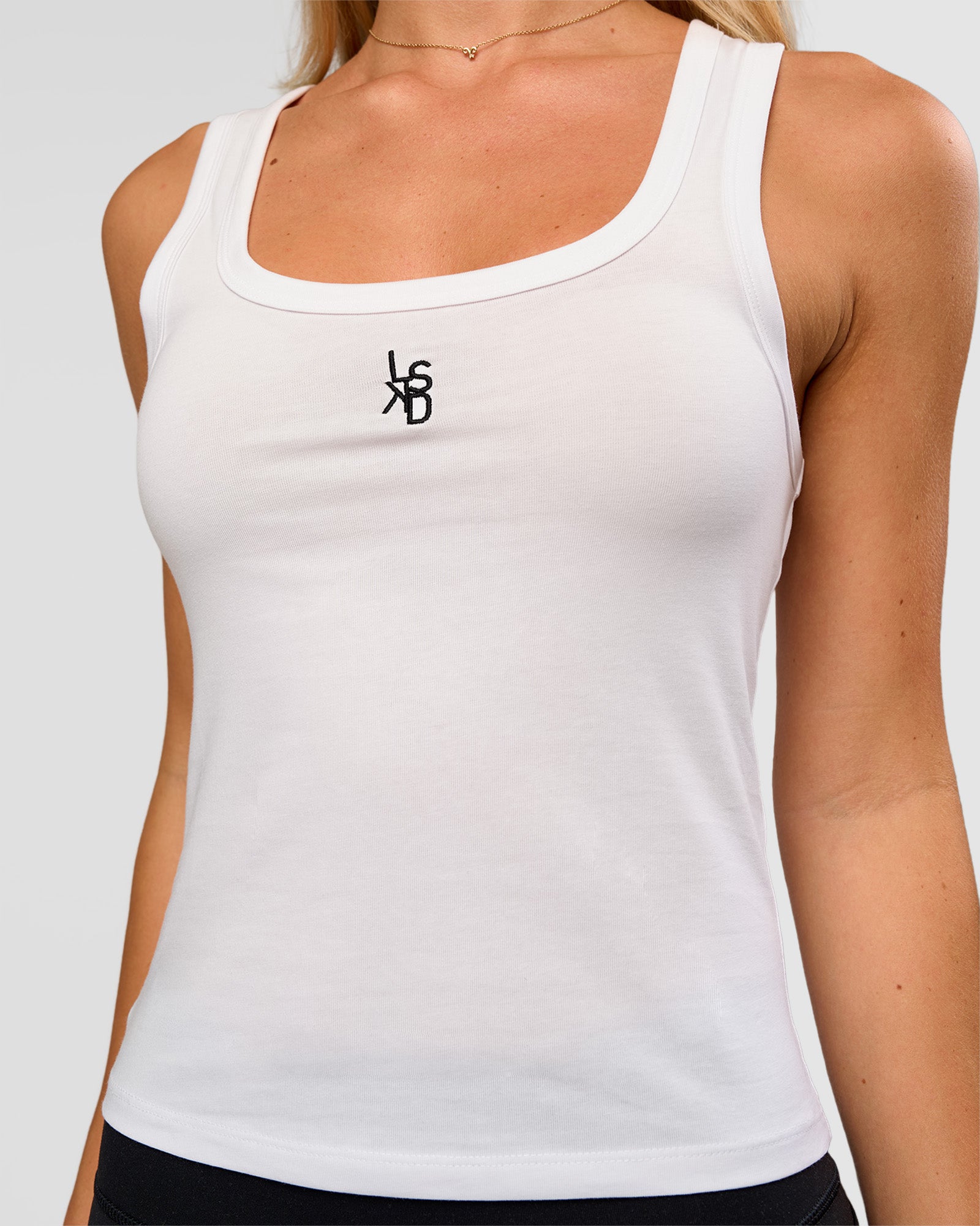 Woman wearing Go-To FLXCotton Scoop Neck Tank in White-Black | Model:Issy | Size:XS