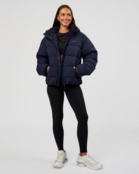Woman wearing Go-To Puffer Jacket - Future Navy | Model:Brylee | Size:XS | Thumbnail Index: 8