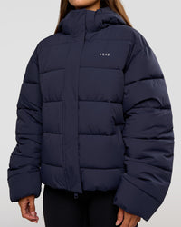 Woman wearing Go-To Puffer Jacket - Future Navy | Model:Brylee | Size:XS | Thumbnail Index: 10